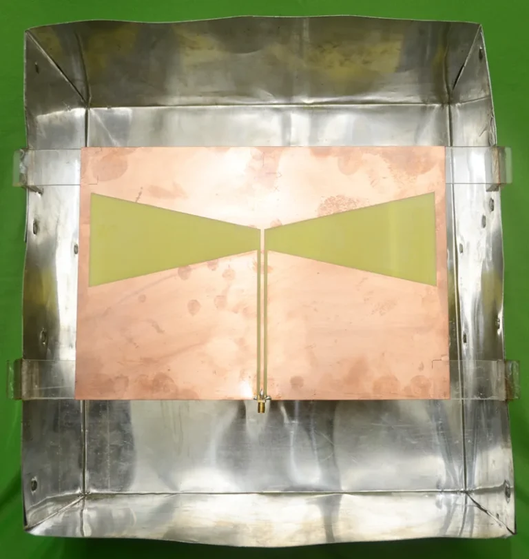 Fabricated 400 MHz cavity-backed CPW-fed bow-tie antenna inside its metal cavity